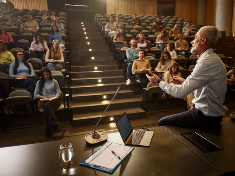 Professor speaking to class in a lecture hall
