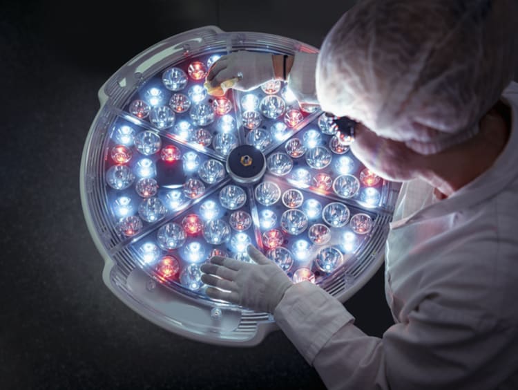Creative Images & Video Search by image or video Female engineer preparing operating theatre light in factory clean room - stock photo
