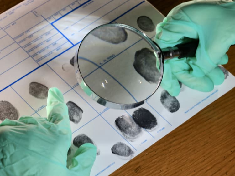 Investigator examining fingerprints