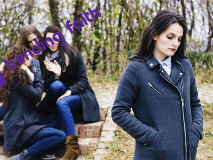 A student being bullied by a group of peers