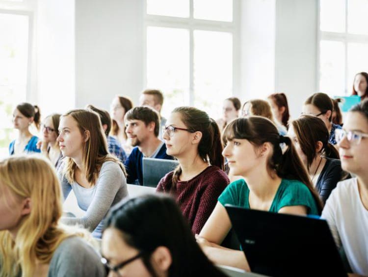 University Students Listening And Concentrating During Lecture