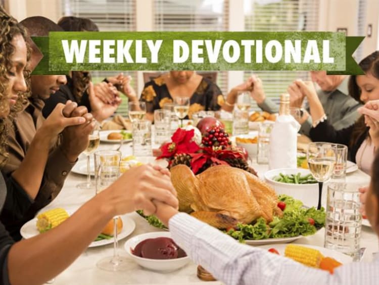 A Thanksgiving table with the Weekly Devotional banner