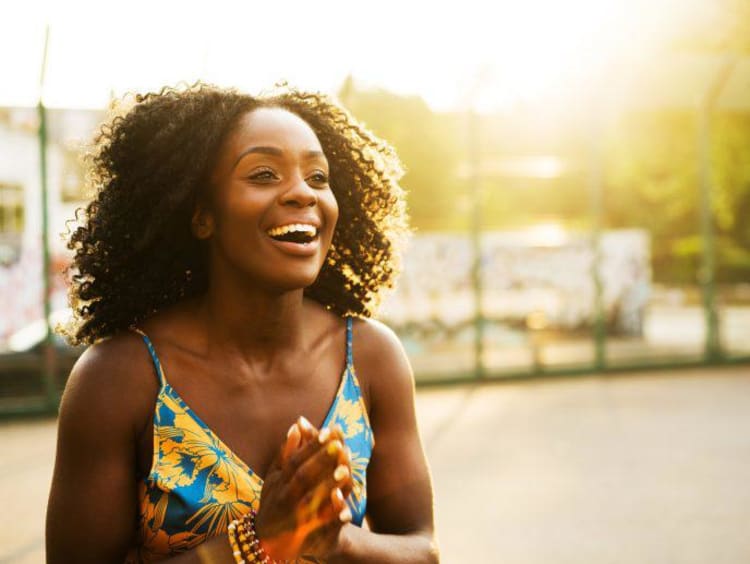 woman smiling and laughing outside