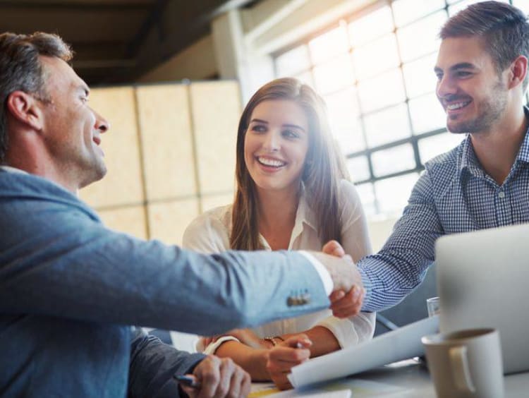 three people meeting and shaking hands