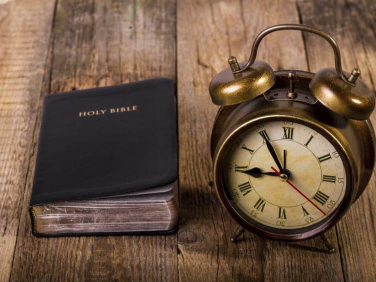 clock and bible on a table