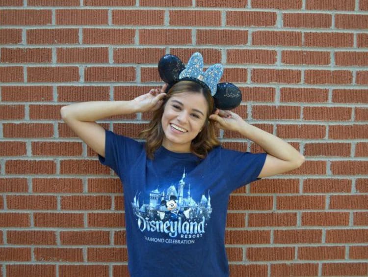 Student poses with Disneyland Resort shirt and Mickey Mouse ears on