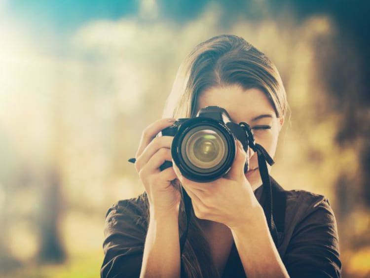 girl holding camera and taking pictures