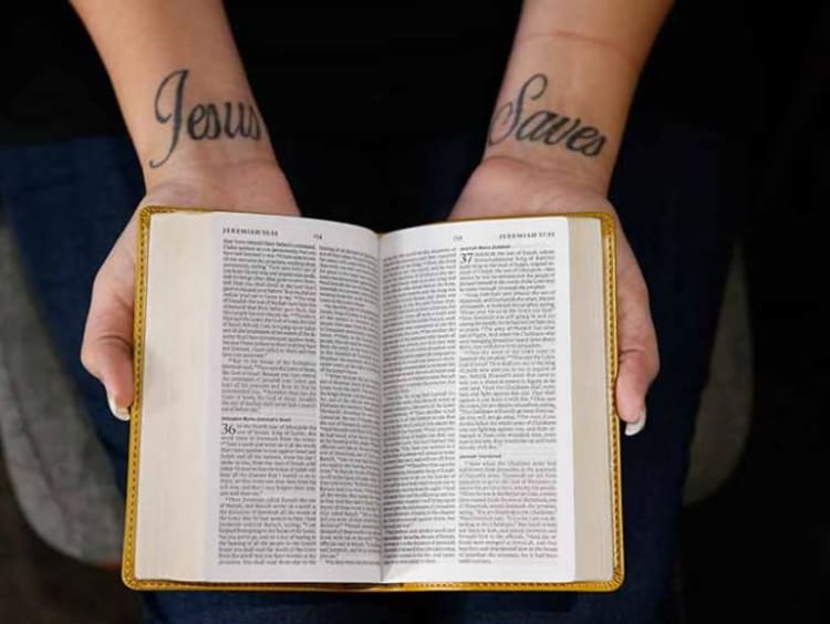 person holding open a bible