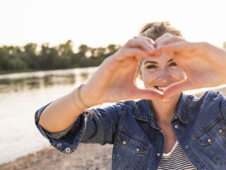 Woman making her hands a heart shape