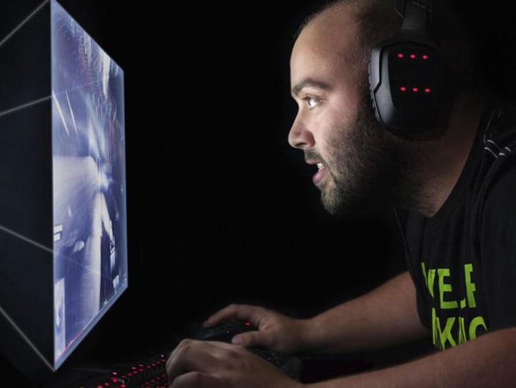 person wearing headphones and looking at a computer