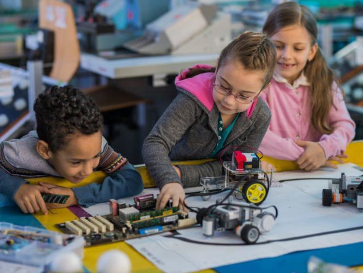 Young children working with robots
