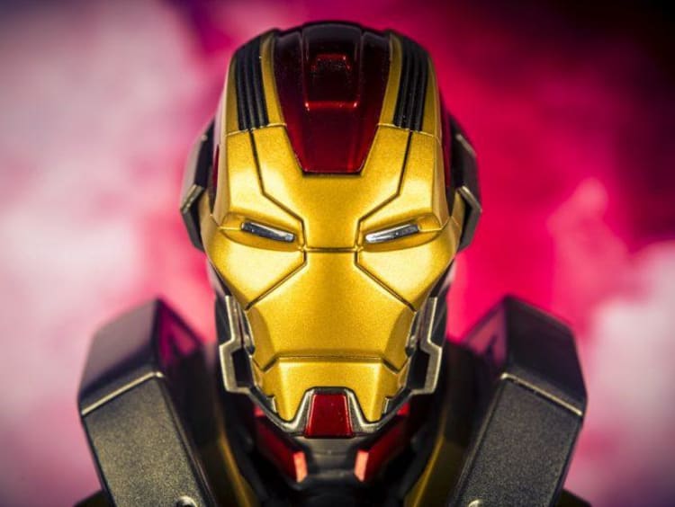 An Iron Man helmet surrounded by red smoke