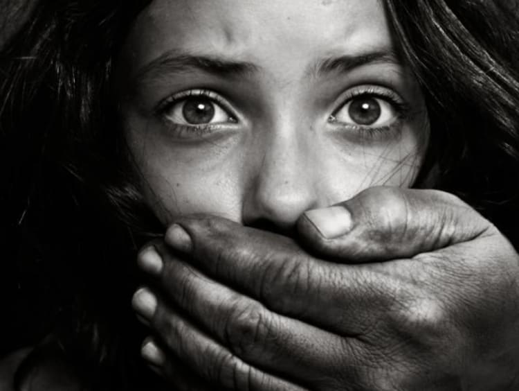 girl putting hand over her mouth
