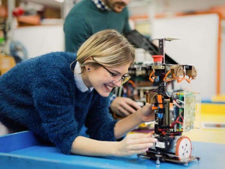 A woman working with a robot