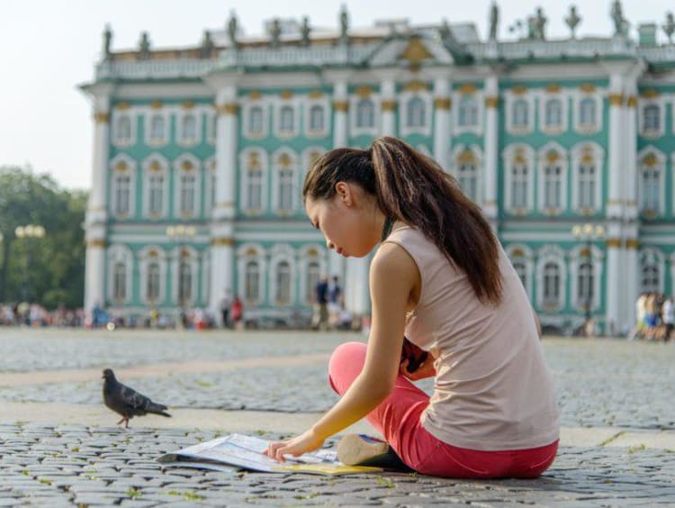 Young female tourist studying map