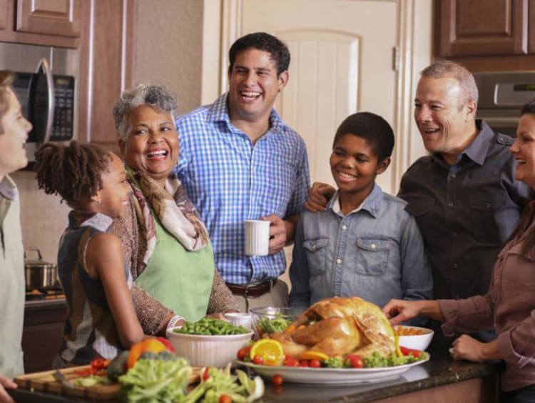 family smiling and laughing in the kitchen