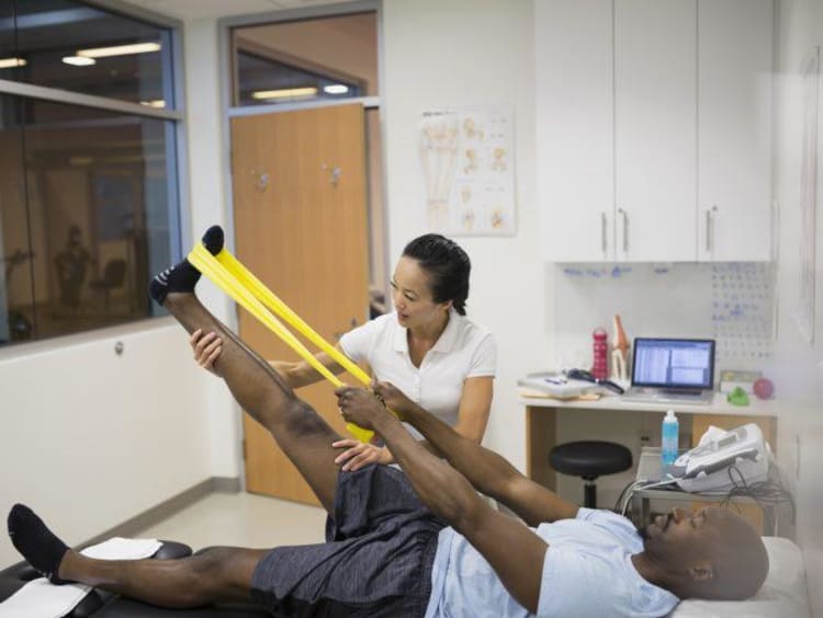 athletic trainer helping client