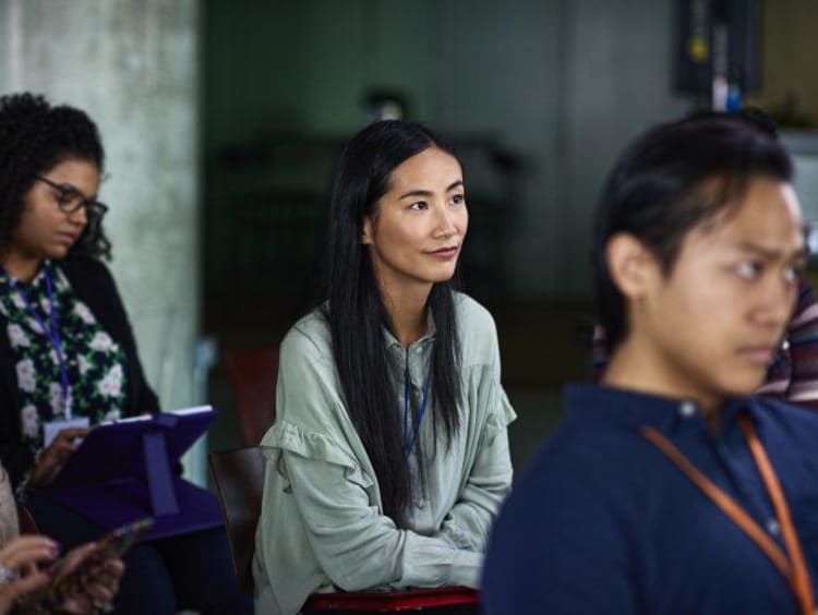 Attentive woman in an audience at a presentation