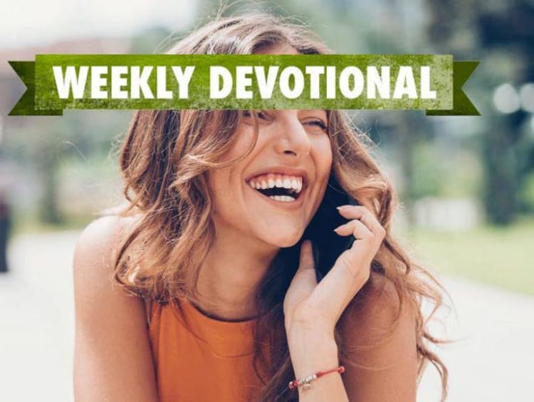 Weekly Devotional: Woman a cellphone smiling