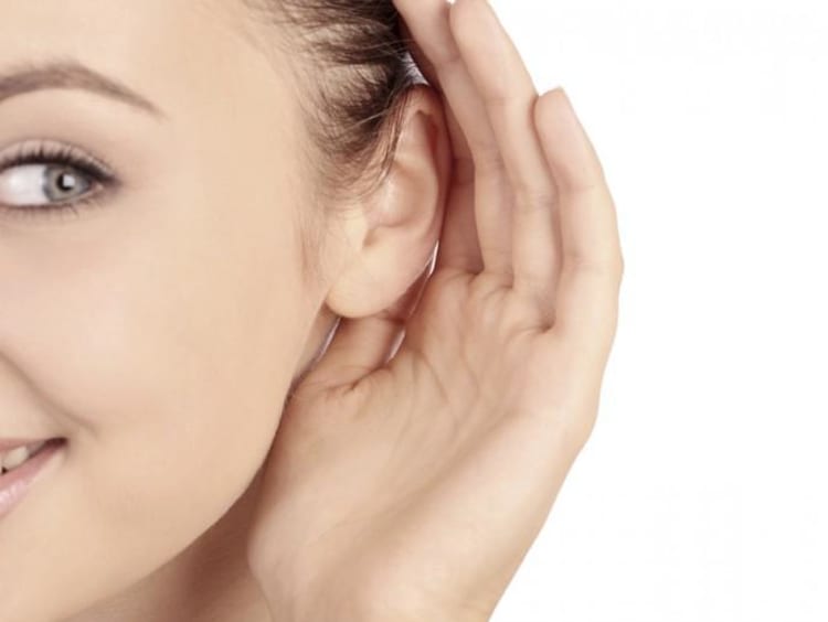 a girl cupping her ear
