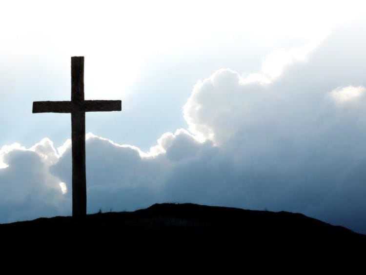 Cross on the hill with cloud in the scenery