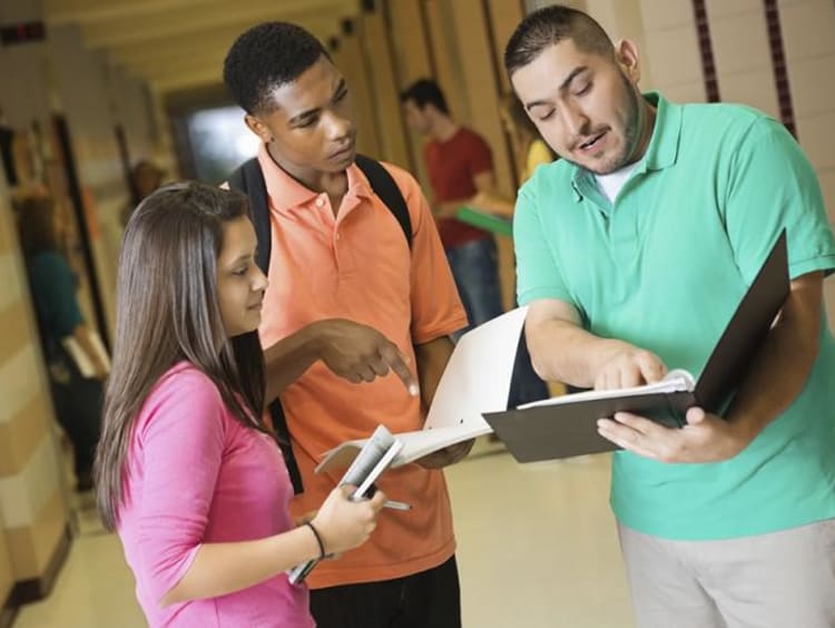 Person showing a folder to two other people