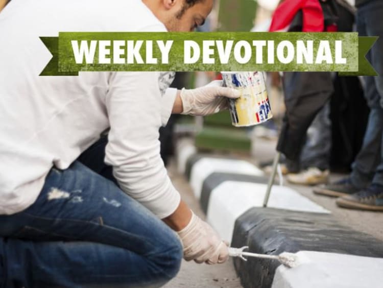 A man painting curbs under the Weekly Devotional banner