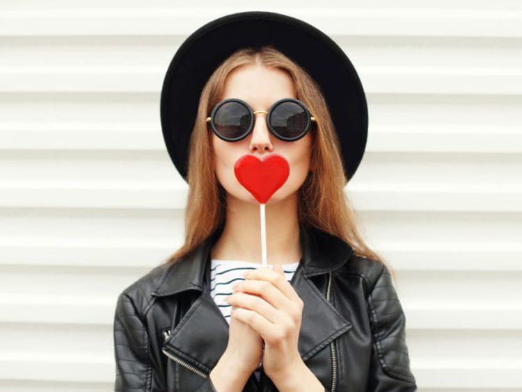 Girl with a heart-shaped lollipop