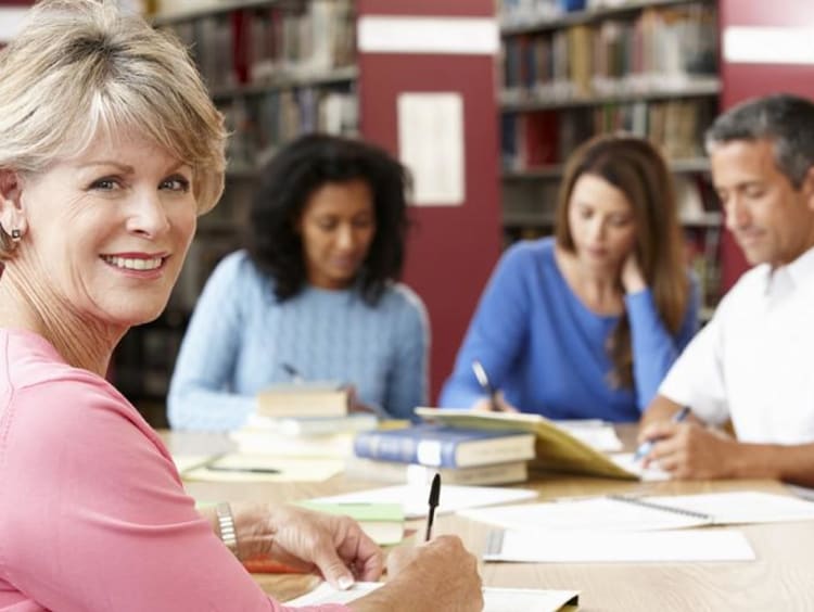 people in the library working together