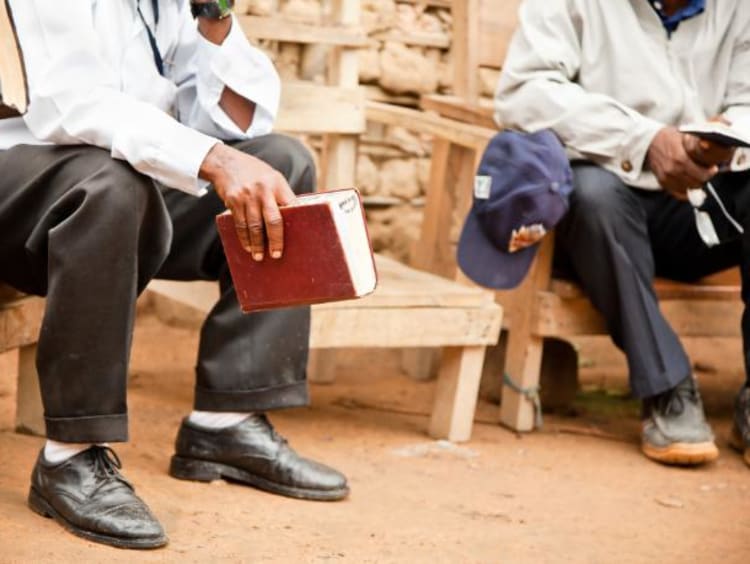 men having a bible study outside