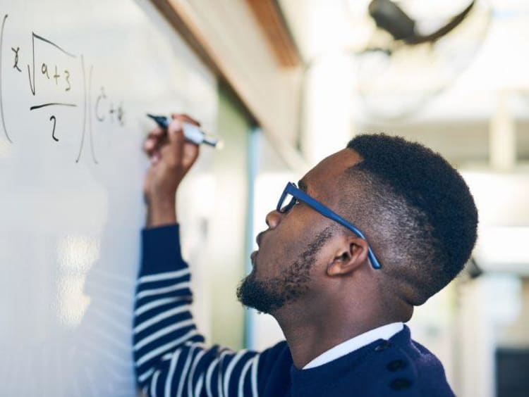 Man writing math on the board