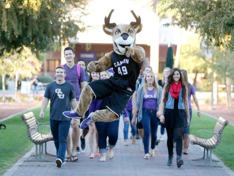 Thunder walking with a group of GCU students on campus