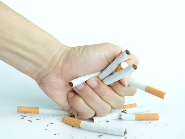 Hand crushing cigarettes
