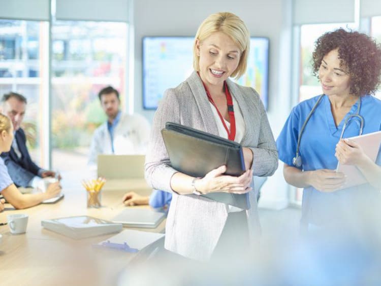 a nurse and administrator talking