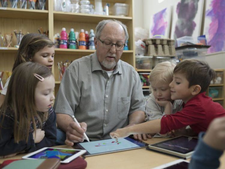 Instructor teaching students on a tablet