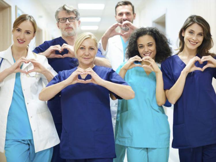 a group of nurses making heart signs