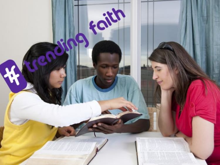 A group of people sitting around a table with the trending faith logo