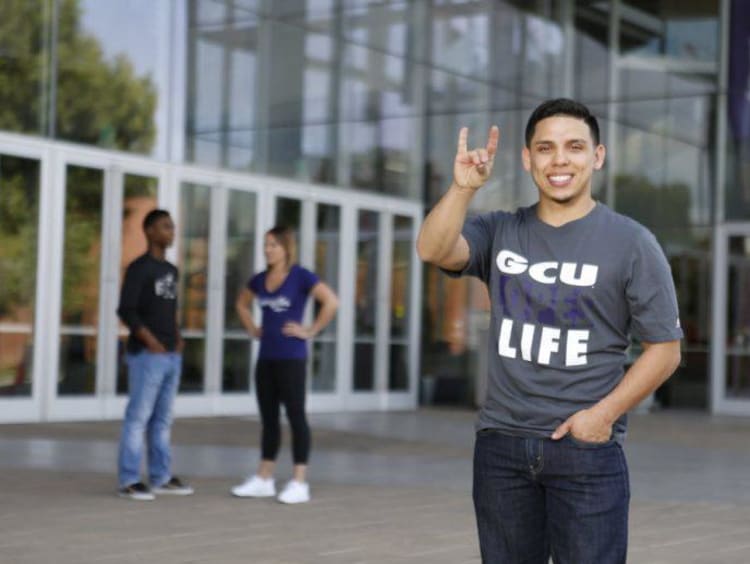 GCU student holding a lopes up