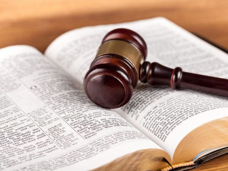 open bible with gavel sitting on top of it
