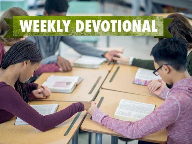 students praying in a group
