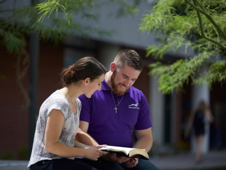 man and woman studying outside