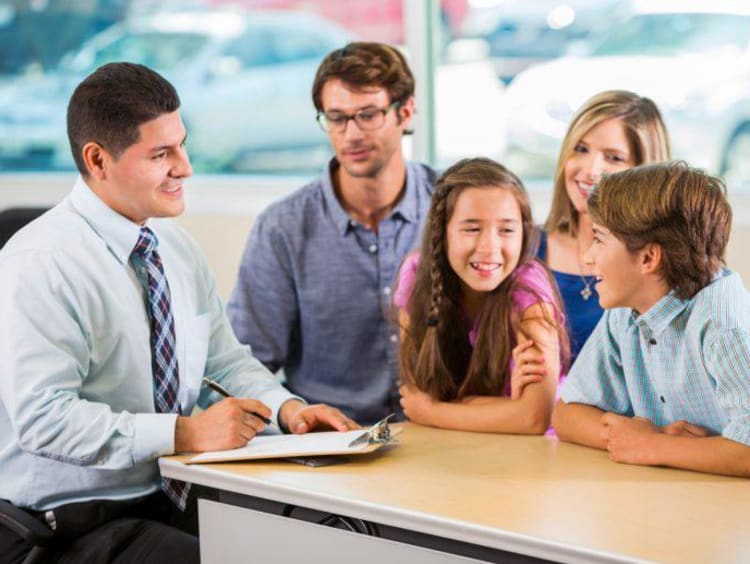Family counselor asks kids questions with parents behind them