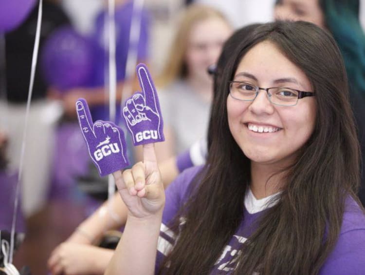 GCU student throwing up a Lope hand sign