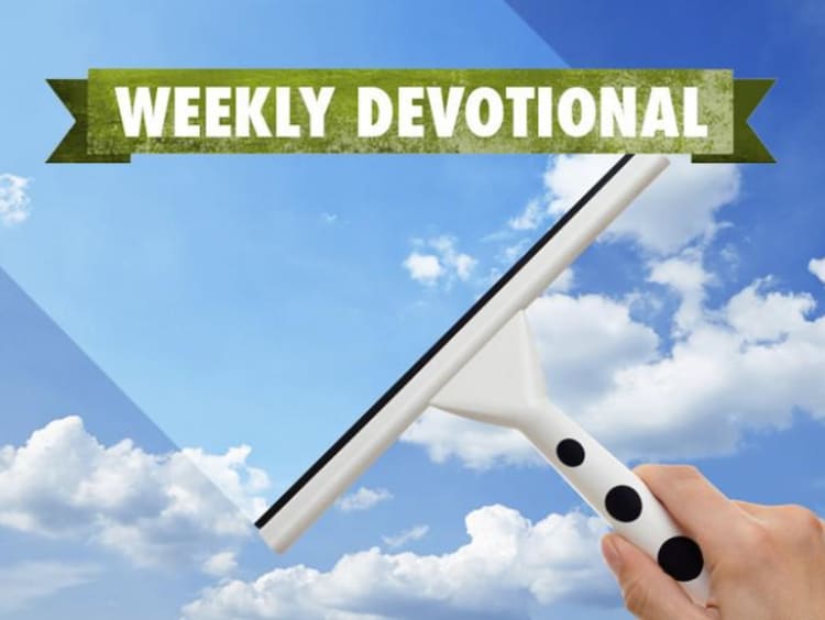 A window being cleaned under the Weekly Devotional banner