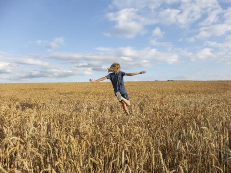 a girl running through a field