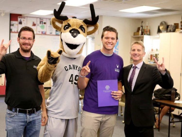 gcu mascot and three people smiling