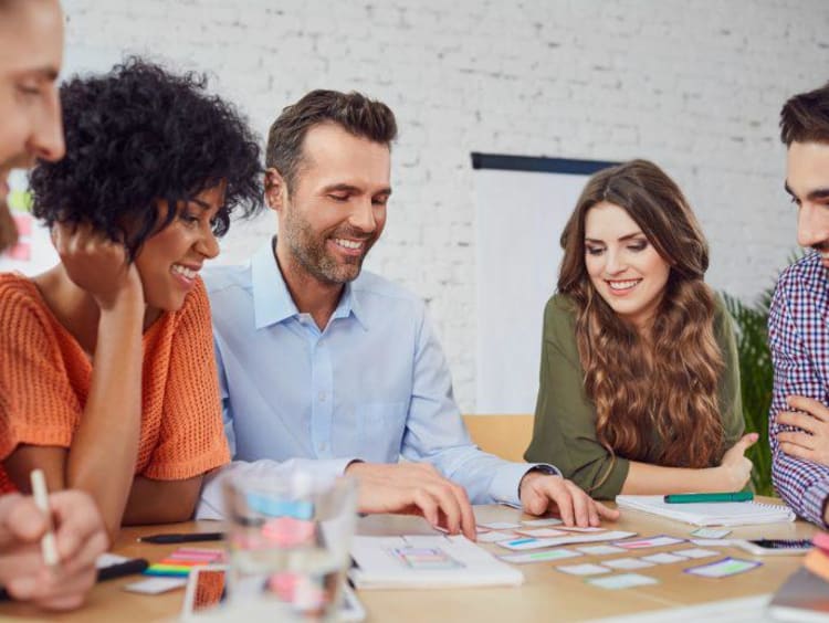Group of professionals talking and smiling