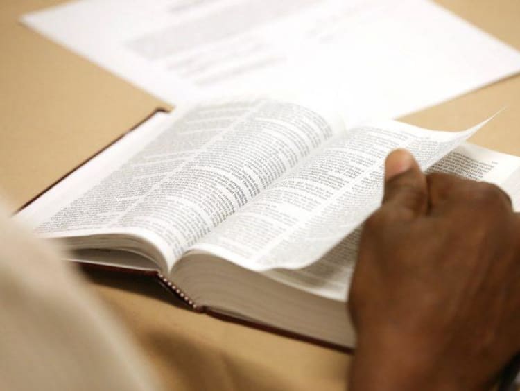 A man reading an open Bible