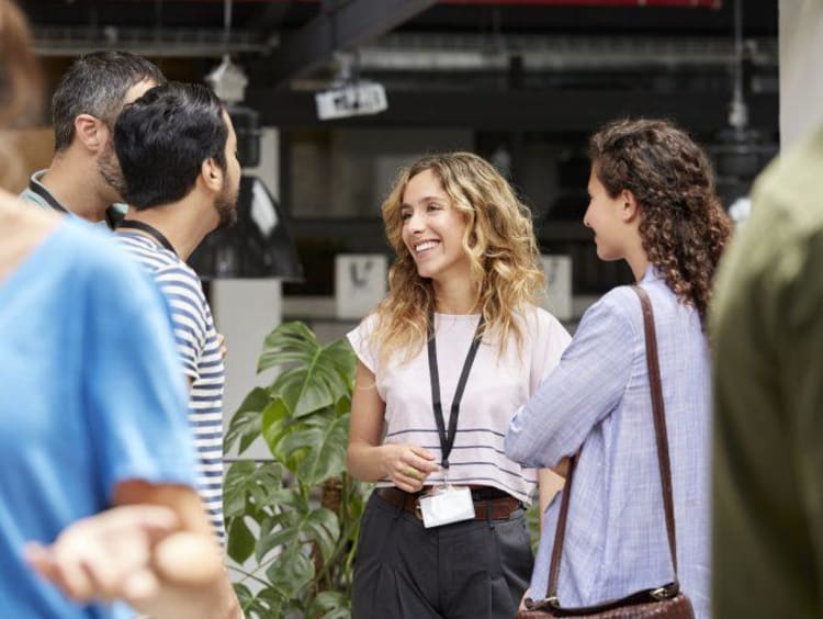 a group of MBA students networking outside of class