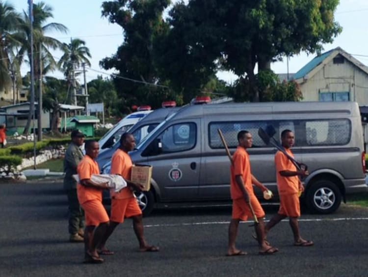people wearing orange carrying different items